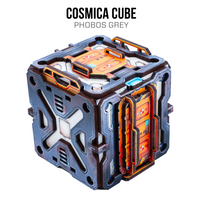 A futuristic metallic cube container labeled 'COSMICA CUBE' with 'PHOBOS GREY' text above it, shown on a plain white background. The cube has a dark gray and black outer shell with orange glowing panel details and small blue accents.